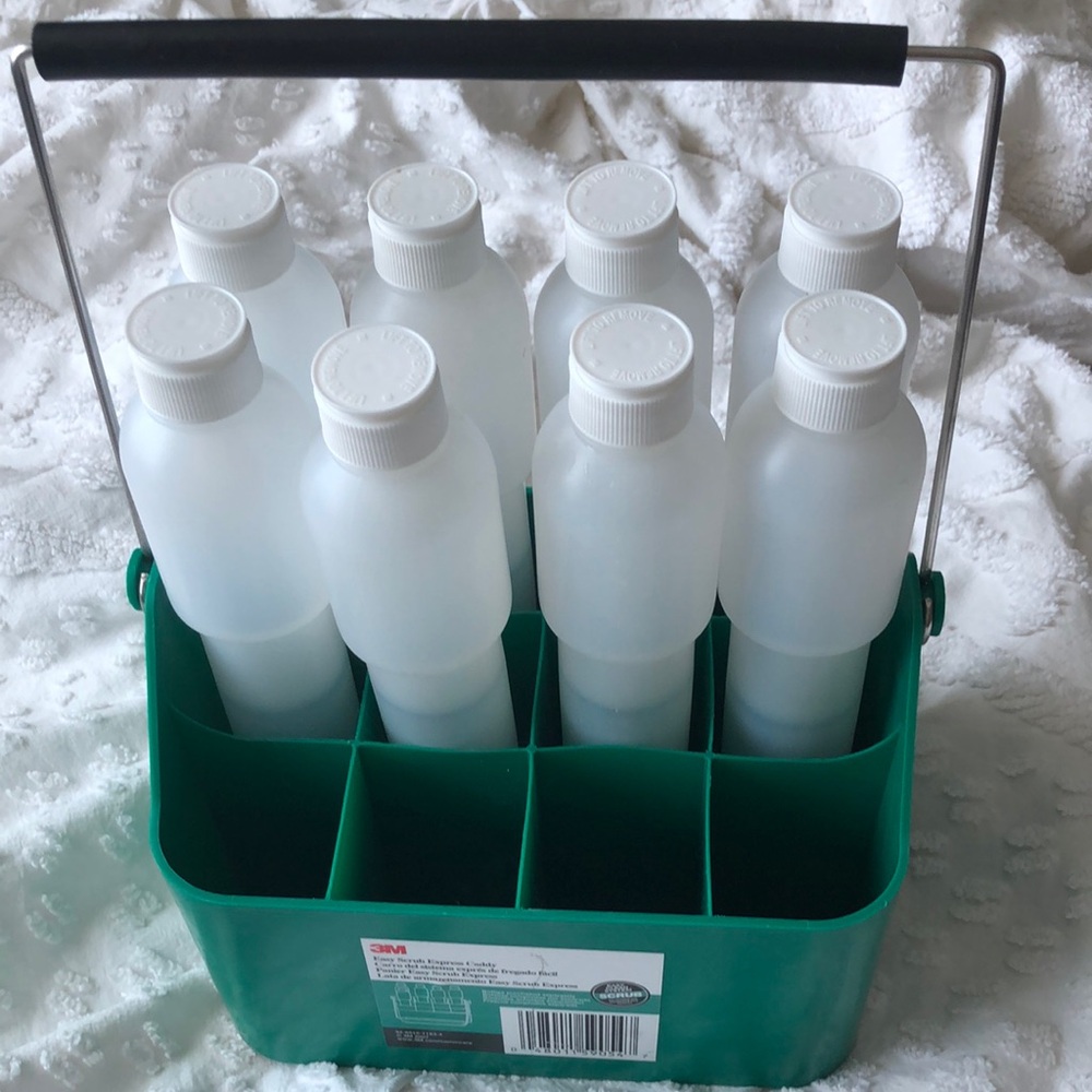 3M easy scrub express caddy with 8 empty bottles . The model holds 12 bottles .